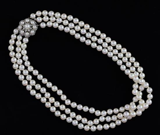 A triple strand cultured pearl choker necklace with 9ct white gold, cultured pearl and diamond set cluster clasp, 38cm.